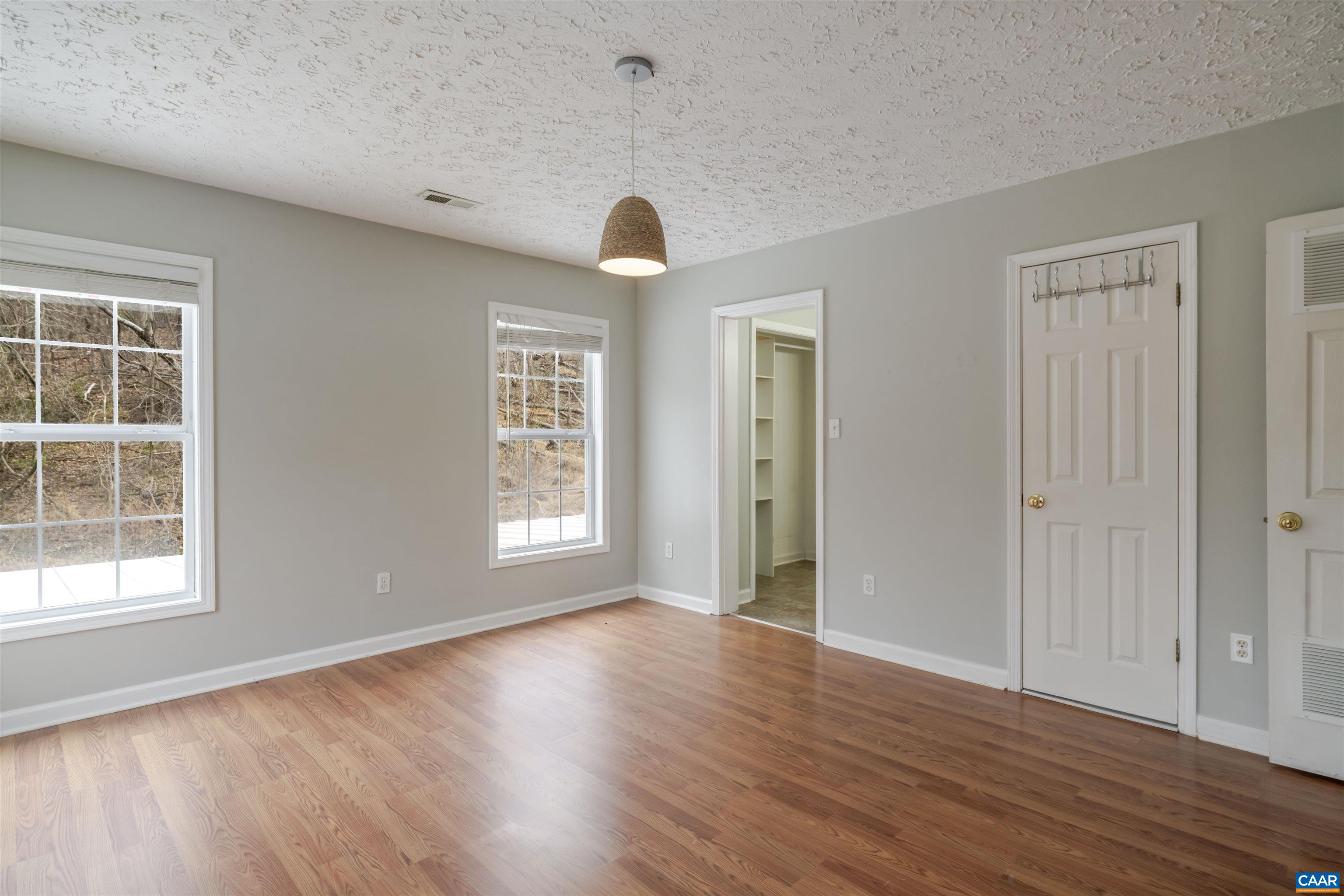 5860 Bearwood Road Crozet, VA 22932 - Photo 33 of 67 a view of an empty room with wooden floor and a window