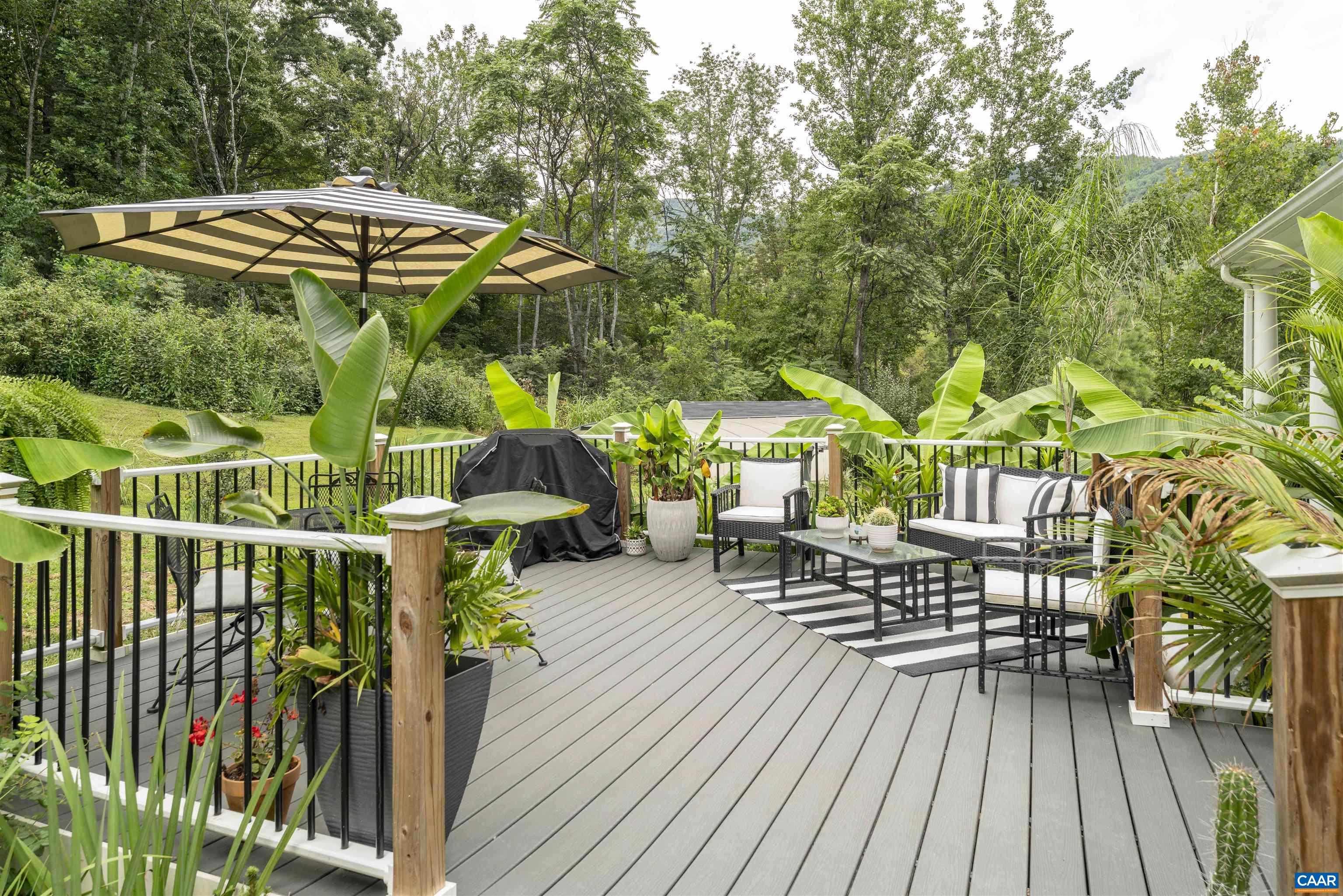 5860 Bearwood Road Crozet, VA 22932 - Photo 48 of 67 a view of patio with table and chairs under an umbrella with wooden floor