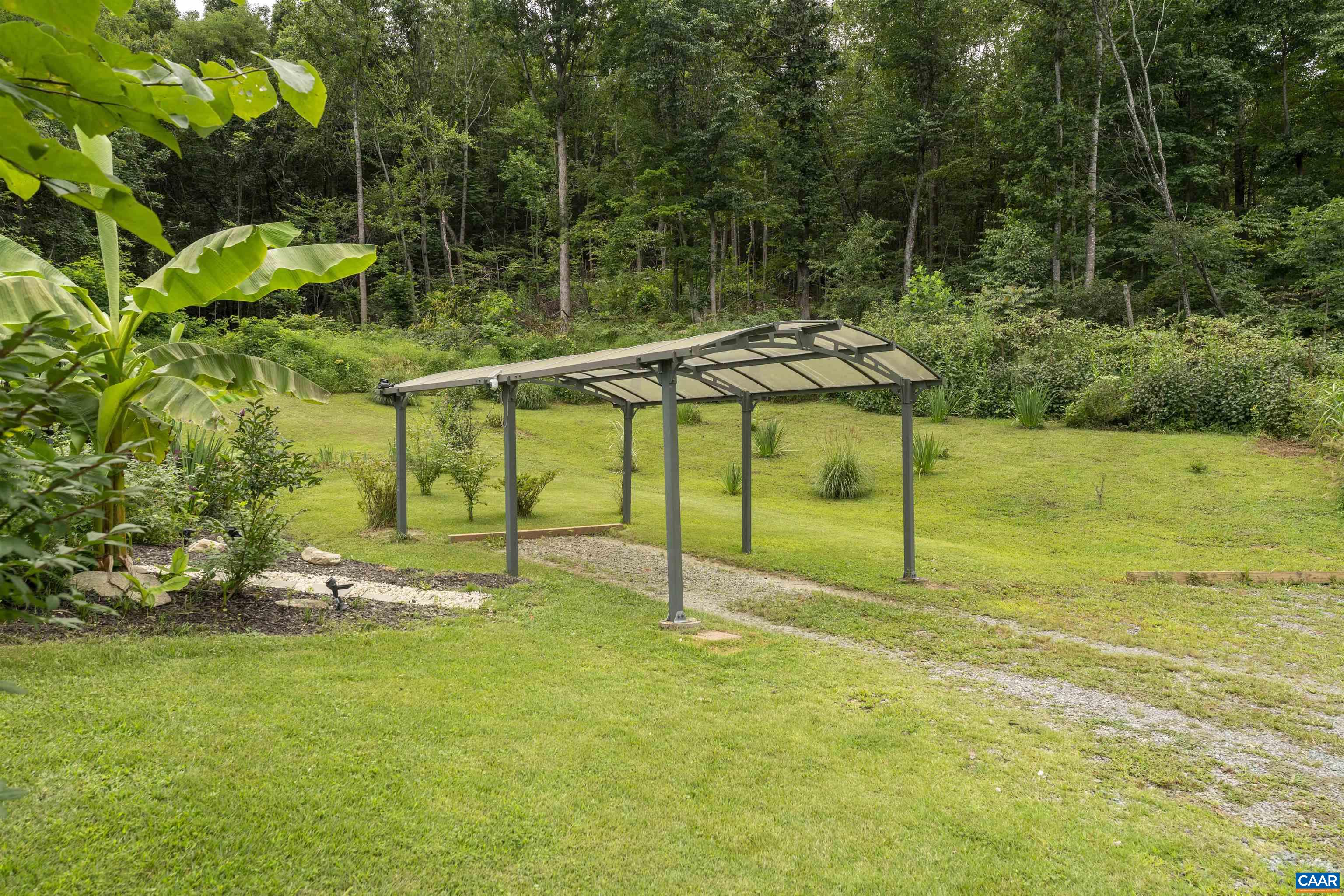 5860 Bearwood Road Crozet, VA 22932 - Photo 63 of 67 a backyard of a house with table and chairs