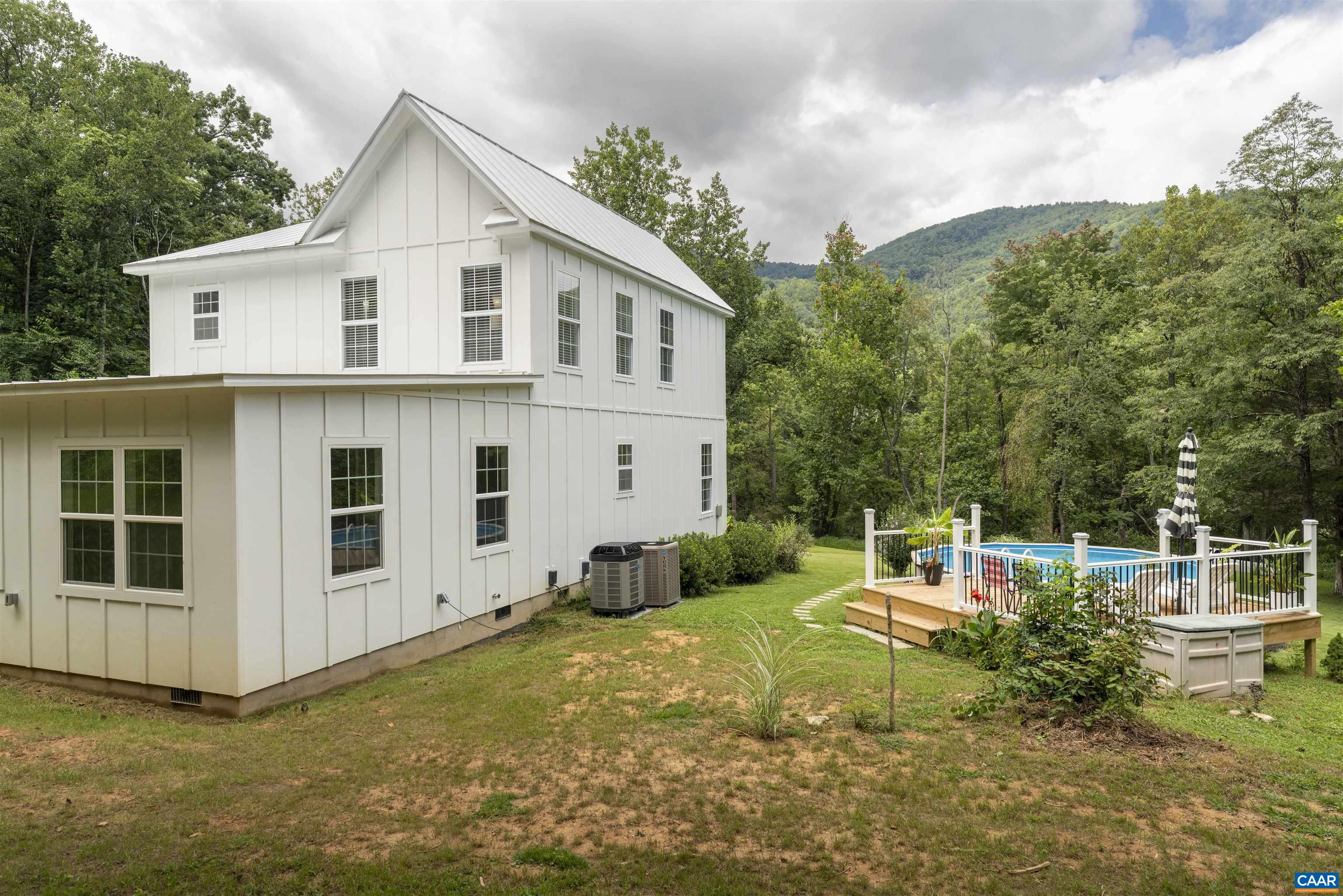 5860 Bearwood Road Crozet, VA 22932 - Photo 66 of 67 a view of a house with backyard sitting area and garden