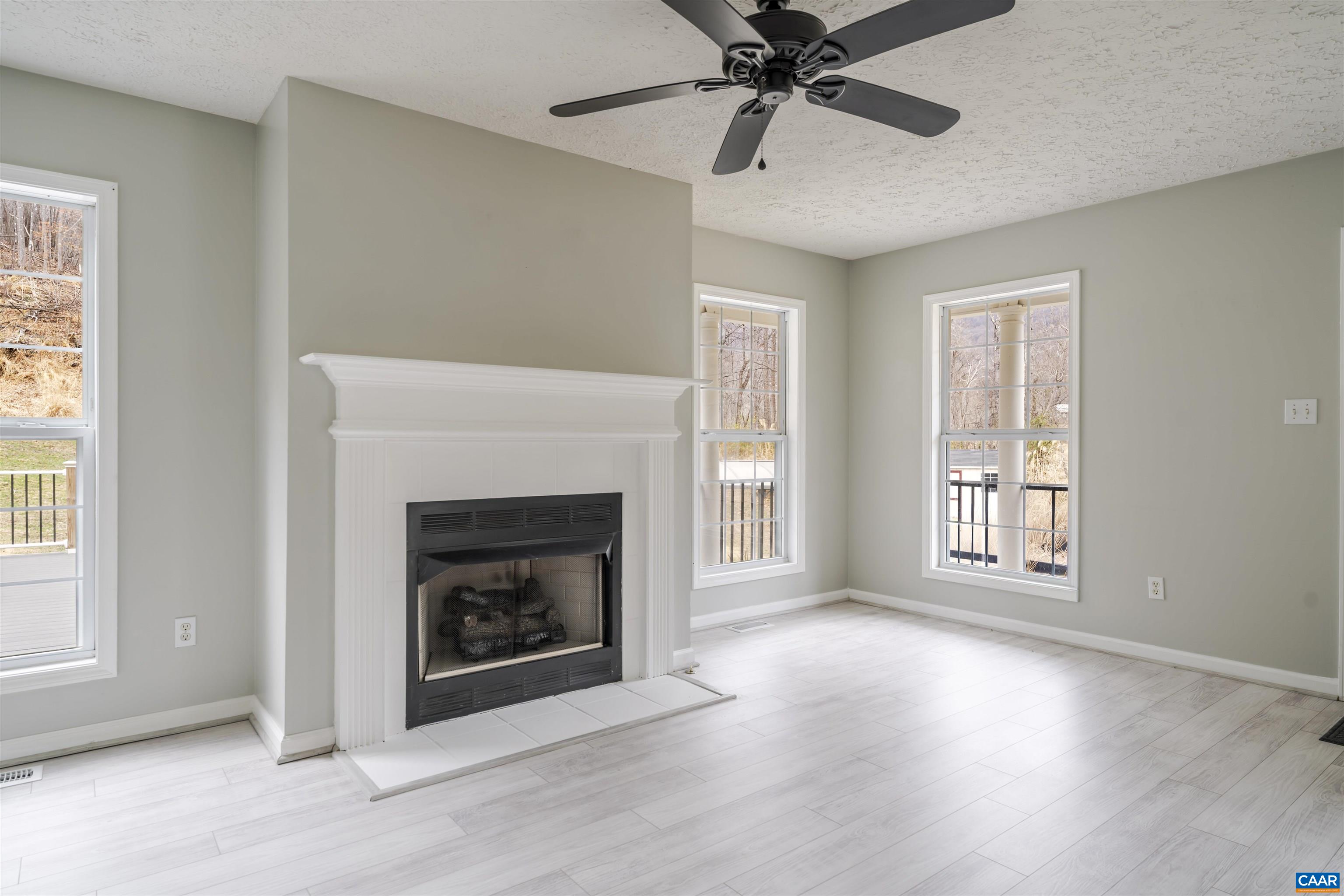 5860 Bearwood Road Crozet, VA 22932 - Photo 10 of 67 a view of an empty room with window and fire place