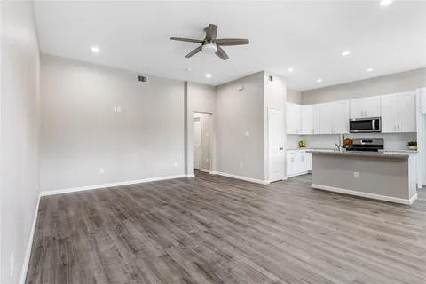 a view of kitchen with granite countertop cabinets and refrigerator