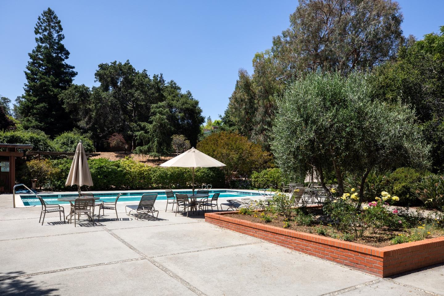2 Farm Road Los Altos, CA 94024 - Photo 17 of 23 a view of a patio with a table and chairs under an umbrella