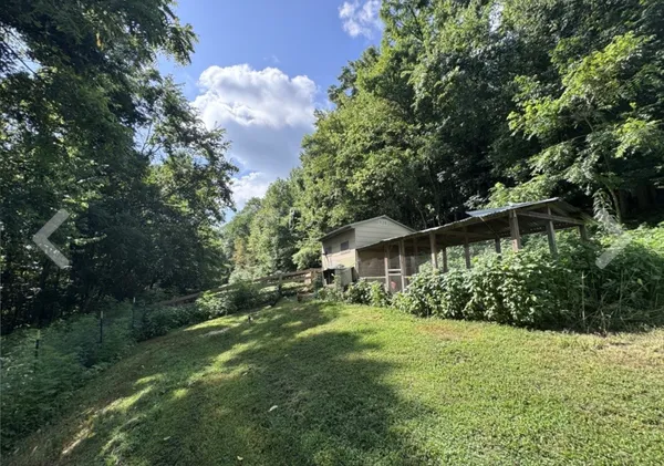 a view of a backyard with chairs and a lake view