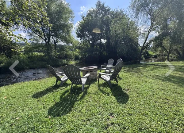 a view of outdoor space with green field and trees