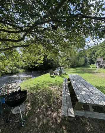 a view of a patio with furniture and a backyard