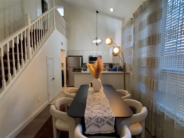 a bedroom with a bed a dresser and a window