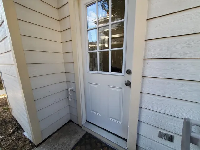 a view of a pathway gate with wooden fence