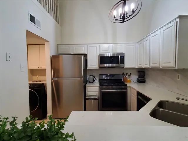 a kitchen with a refrigerator and a sink