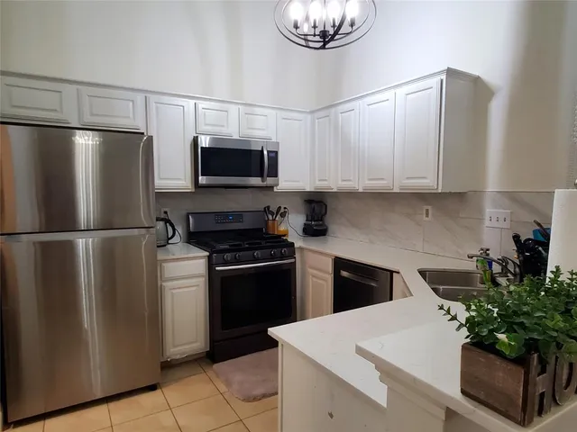 a kitchen with a refrigerator and a sink