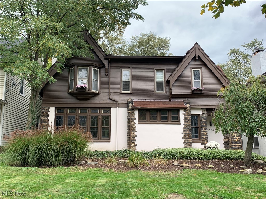 1509 Rydalmount Road Cleveland Heights, OH 44118 - Photo 1 of 12 View of front of property with stucco siding and a front lawn