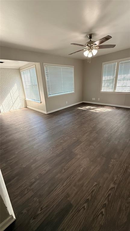 1309 Anna Street Denton, TX 76201 - Photo 3 of 13 Unfurnished room featuring ceiling fan, dark wood-style flooring, and healthy amount of natural light