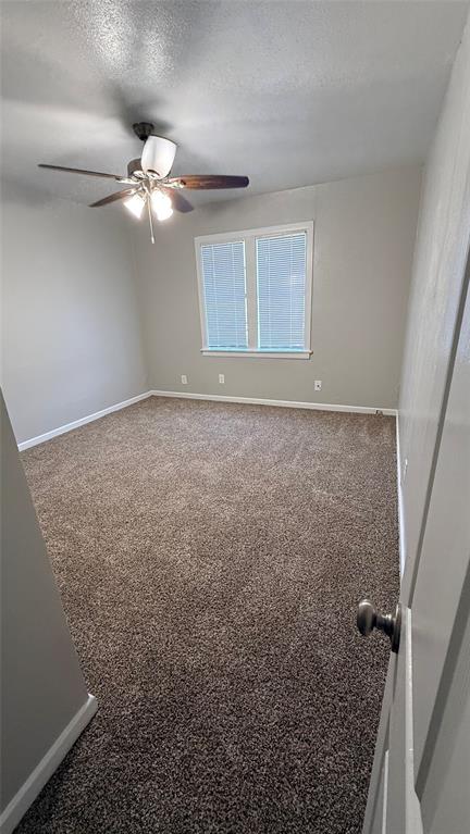 1309 Anna Street Denton, TX 76201 - Photo 8 of 13 Carpeted empty room with a textured ceiling and a ceiling fan