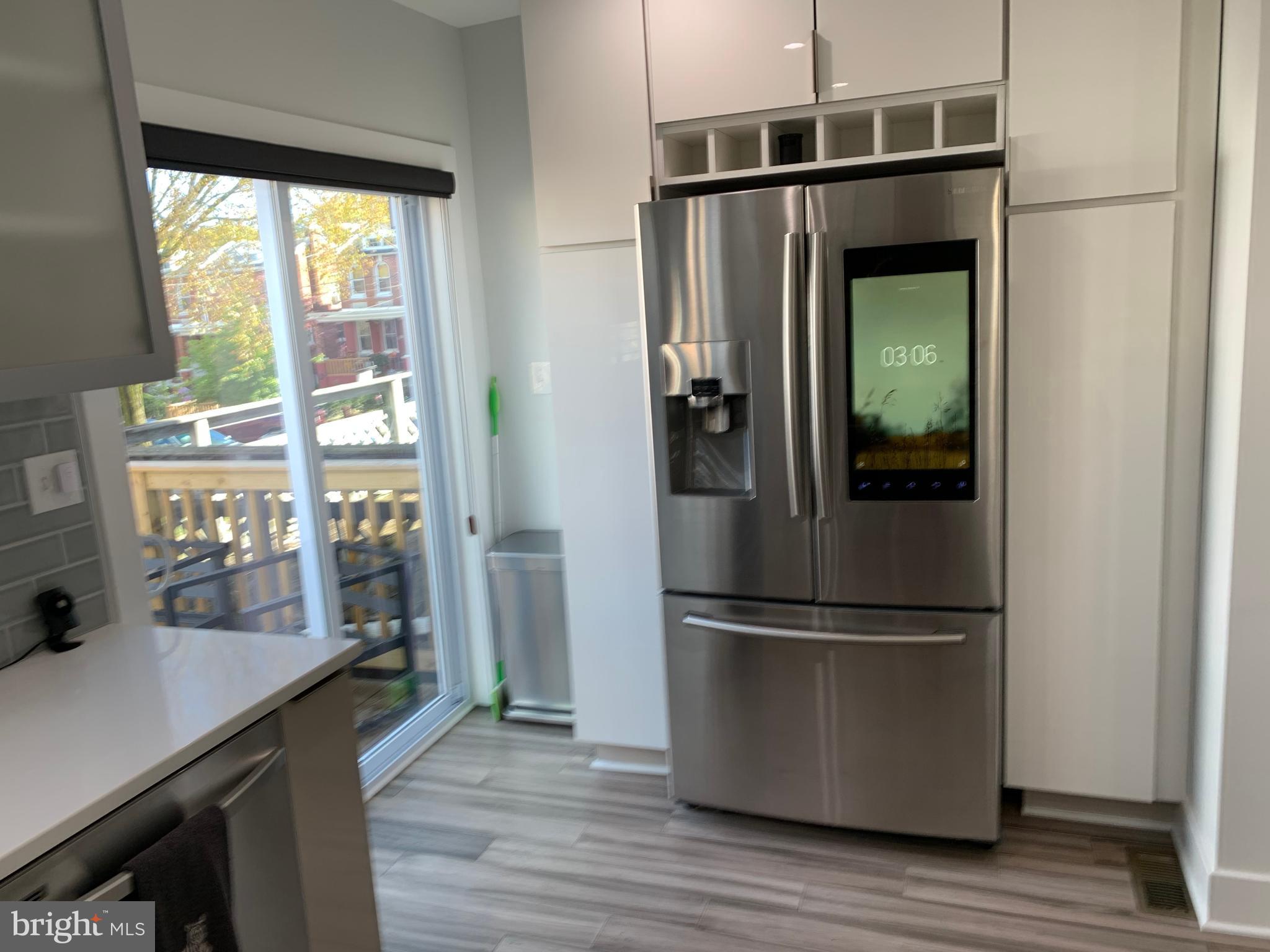6303 9th Street Northwest Washington, DC 20011 - Photo 13 of 45 a kitchen with a refrigerator and wooden floor
