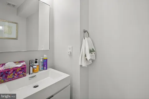 a bathroom with a sink vanity and tub