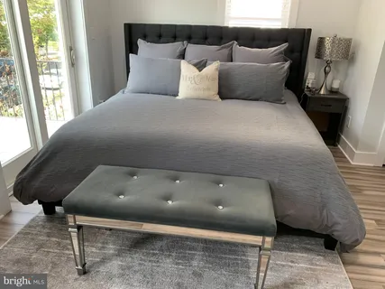 a bed sitting in a bedroom next to a window