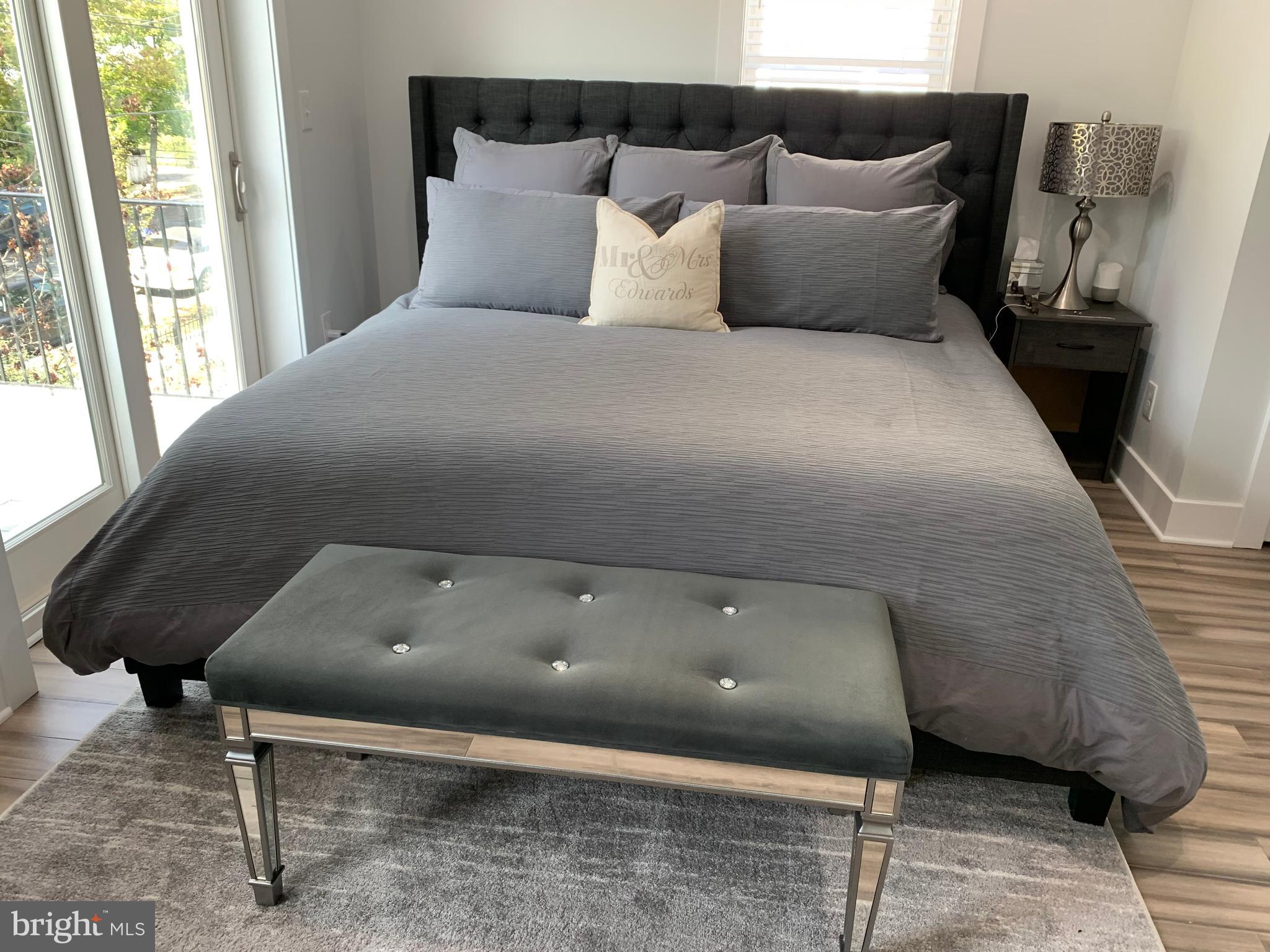 6303 9th Street Northwest Washington, DC 20011 - Photo 17 of 45 a bed sitting in a bedroom next to a window