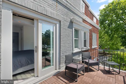 a view of backyard with outdoor seating and plants