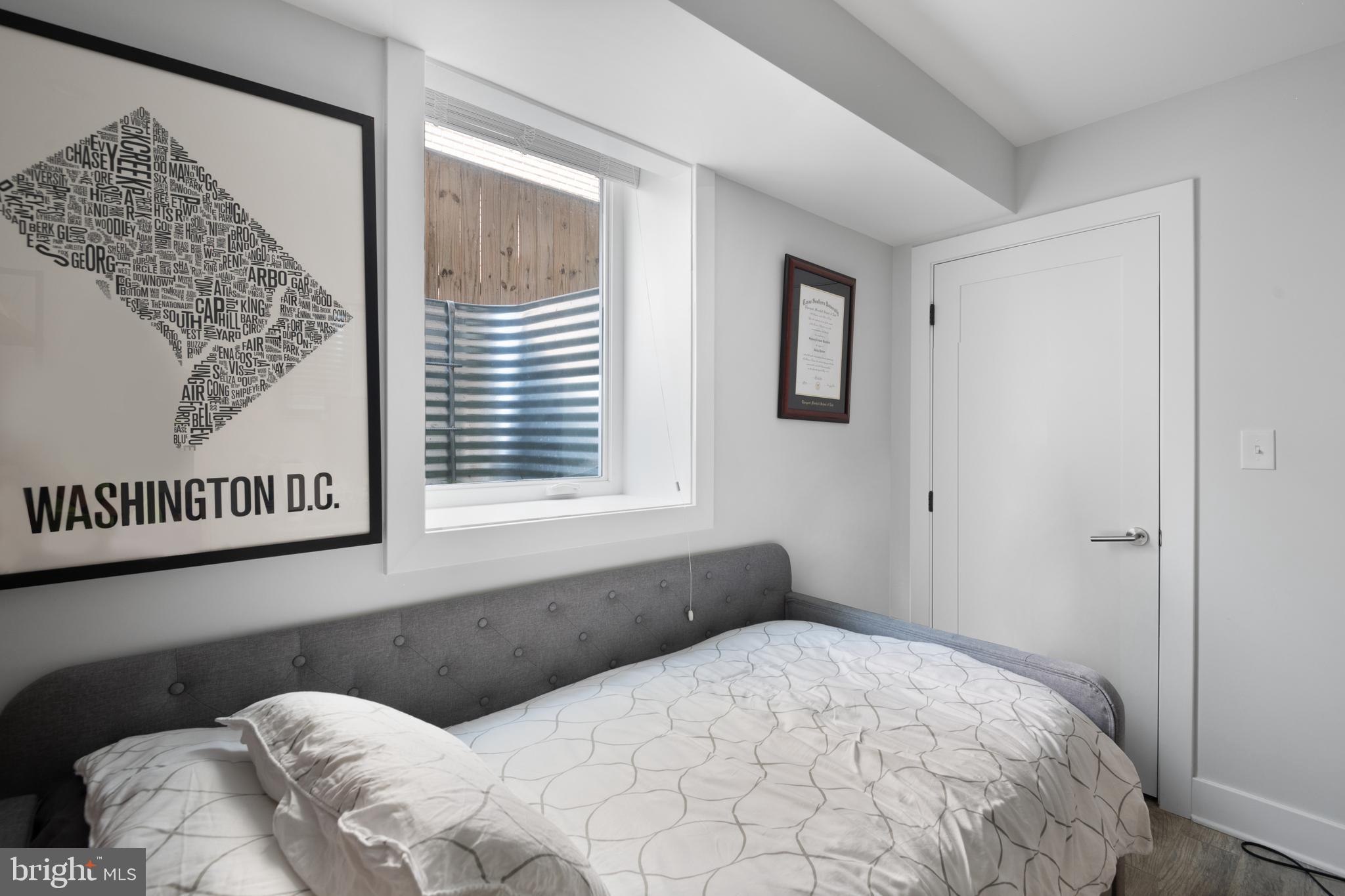 6303 9th Street Northwest Washington, DC 20011 - Photo 31 of 45 a bedroom with a bed and a window