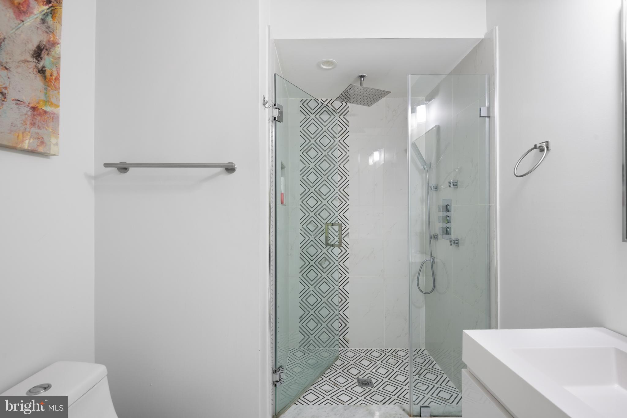 6303 9th Street Northwest Washington, DC 20011 - Photo 32 of 45 a bathroom with a shower a sink and toilet