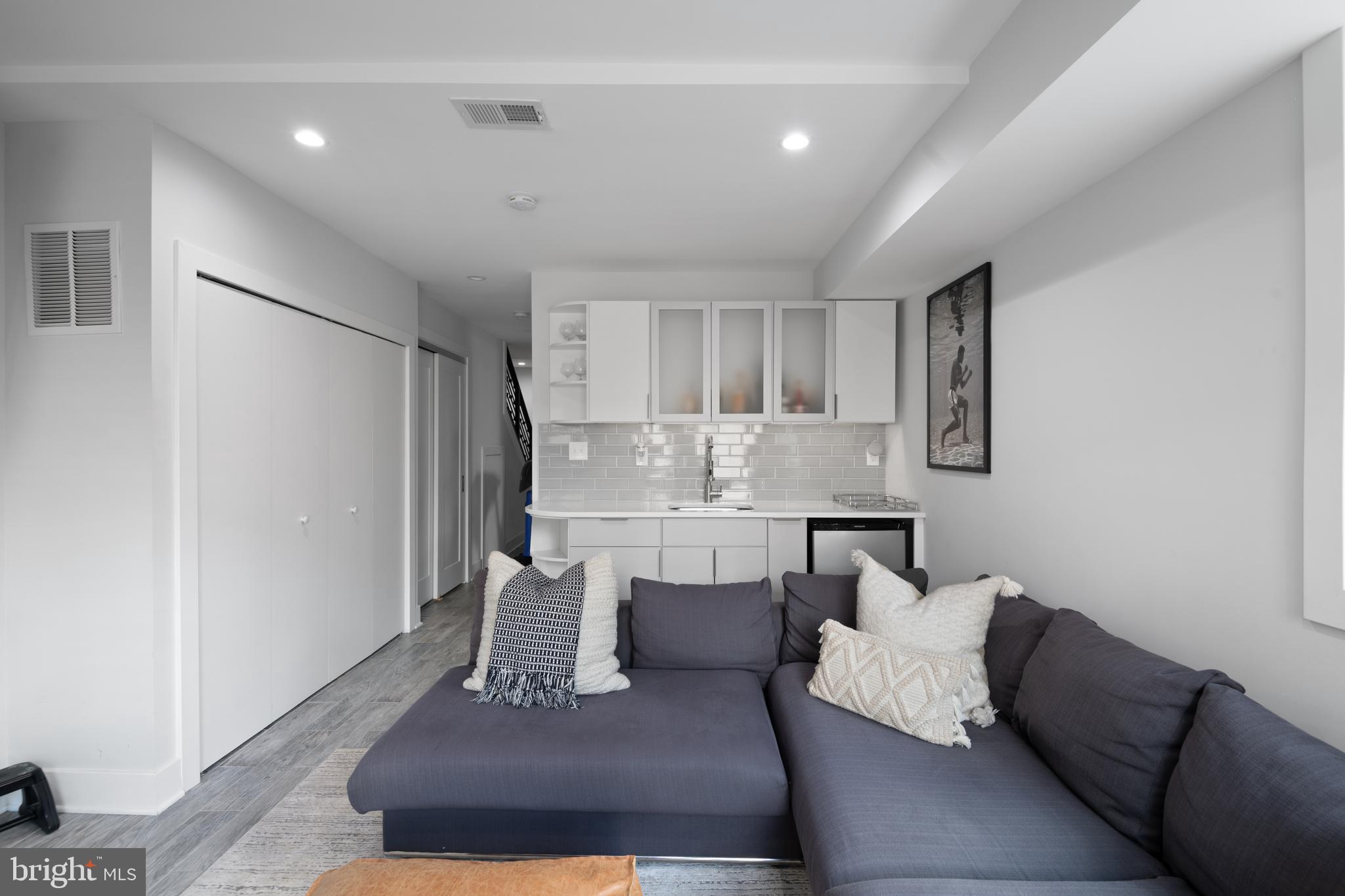 6303 9th Street Northwest Washington, DC 20011 - Photo 37 of 45 a living room with furniture and a dining table with wooden floor