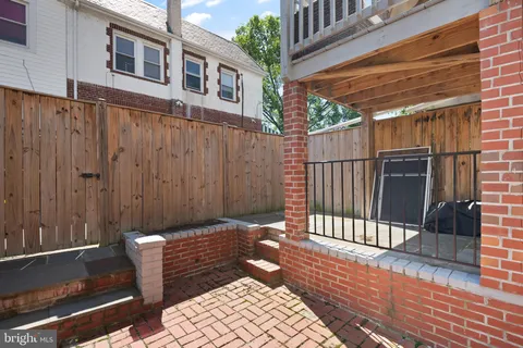 a view of a house with a wooden fence