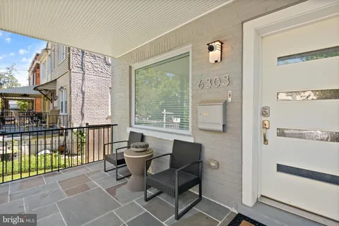 a view of a balcony with chairs and a table