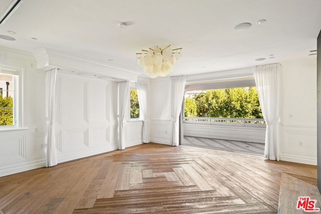 a view of a room with a window and a chandelier