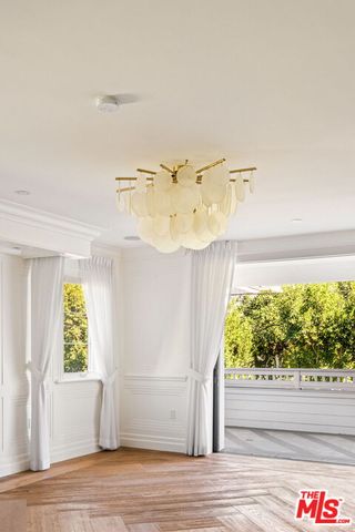 a view of a room that has a window and a bed