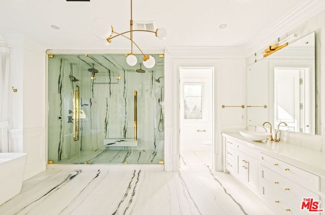 a bathroom with a double vanity sink mirror and shower