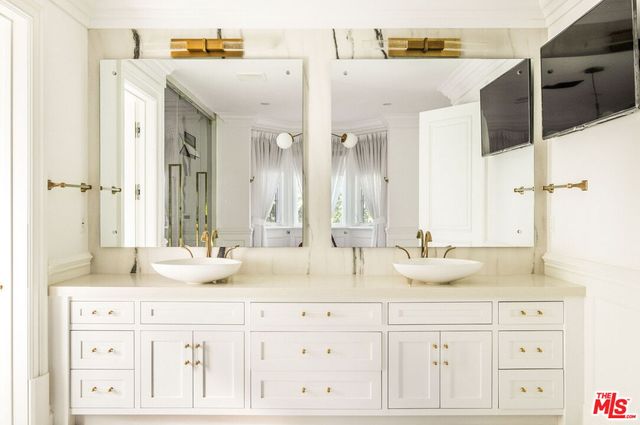 a bathroom with a double vanity sink mirror and