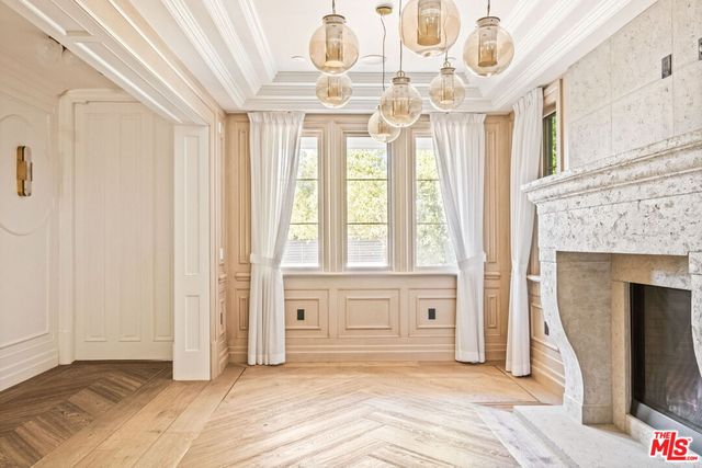 a view of a livingroom with wooden floor and a fireplace