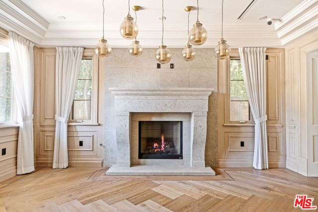 a living room with a fireplace cabinet and a fireplace