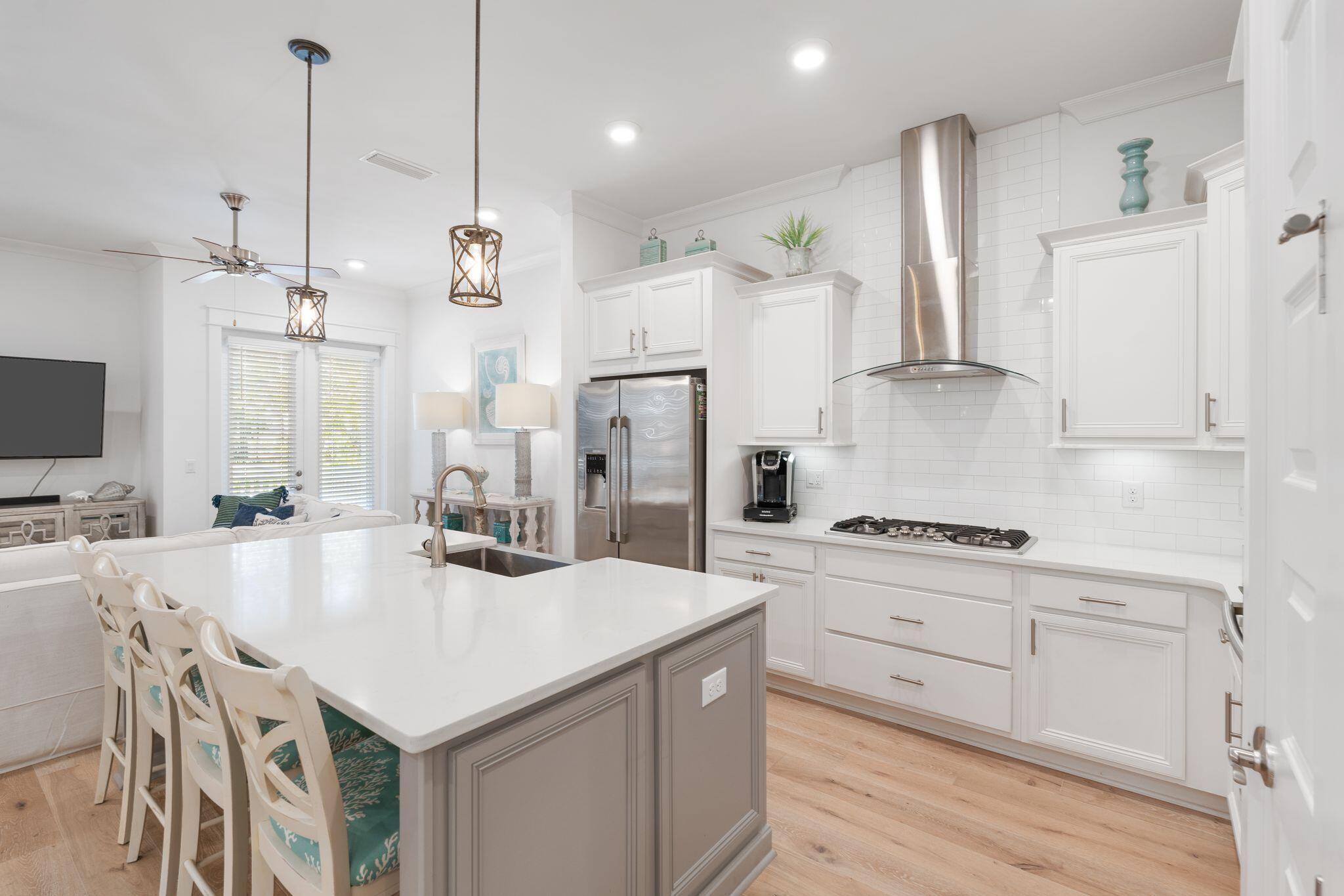 a kitchen with refrigerator cabinets and wooden floor