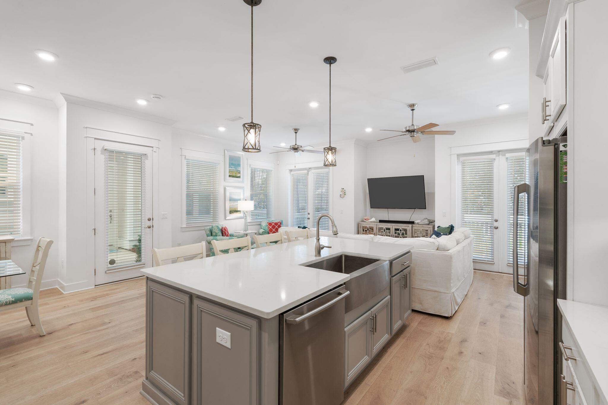 111 Pine Lands Loop East, Unit A Inlet Beach, FL 32461 - Photo 11 of 54 a view of a kitchen with kitchen island a sink stainless steel appliances and living room view