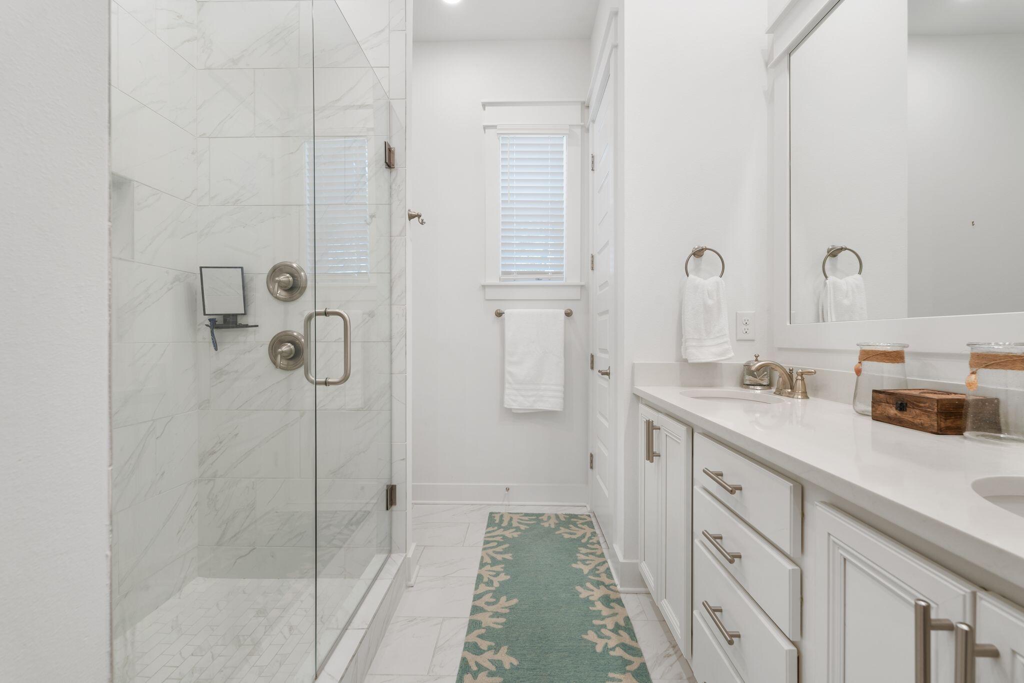 111 Pine Lands Loop East, Unit A Inlet Beach, FL 32461 - Photo 29 of 54 a spacious bathroom with double vanity sink a mirror and shower