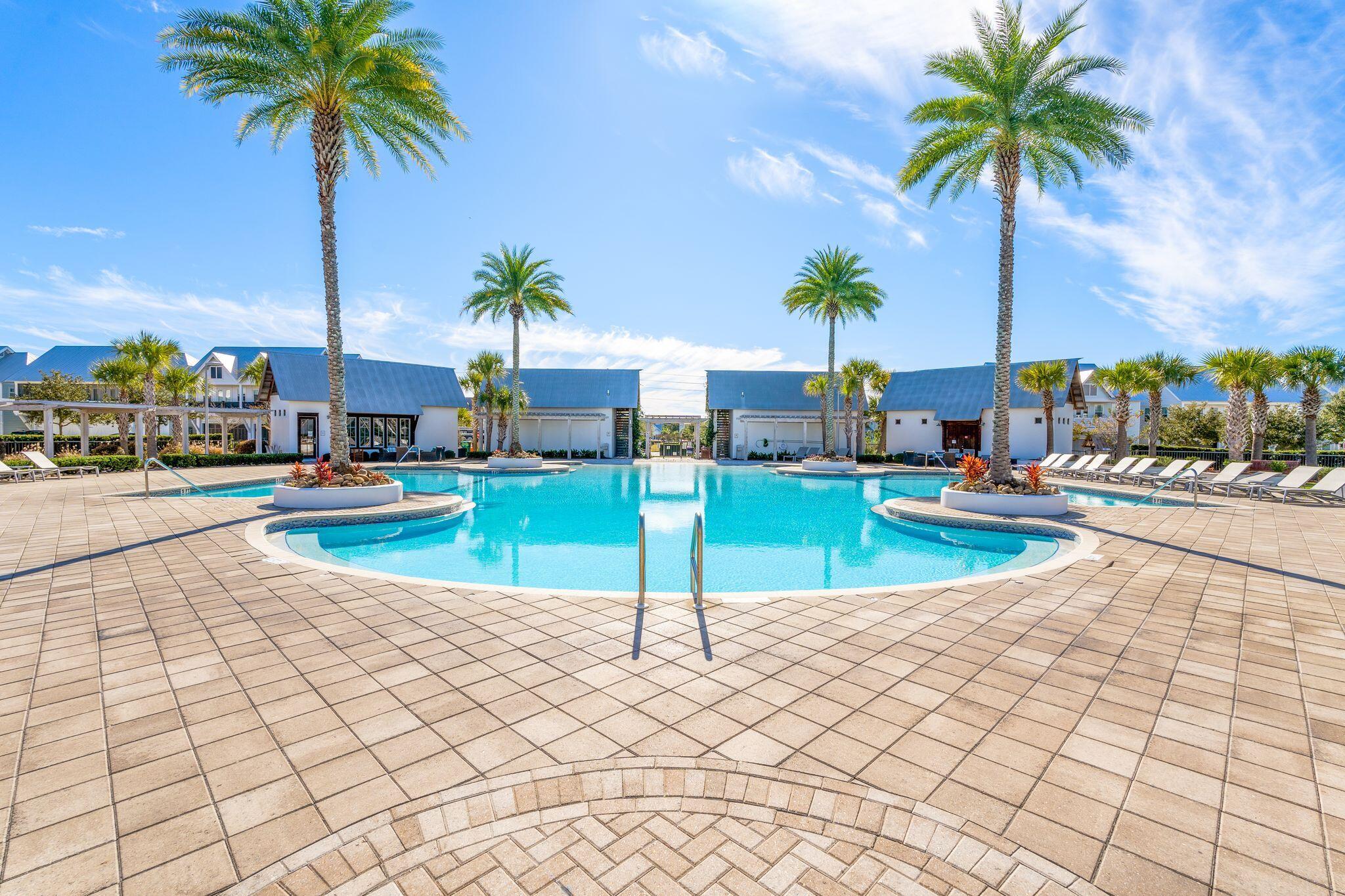 111 Pine Lands Loop East, Unit A Inlet Beach, FL 32461 - Photo 35 of 54 a view of a swimming pool with a table and chairs