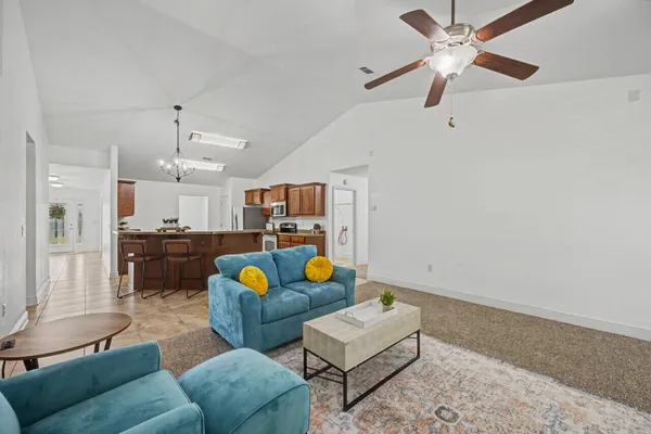a living room with furniture and kitchen view