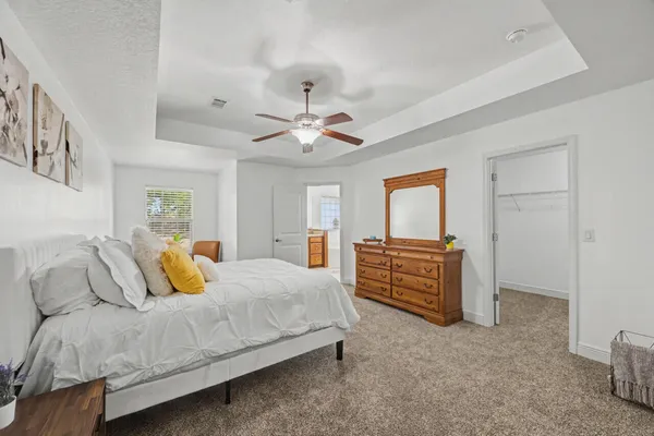 a bedroom with a bed and a chandelier