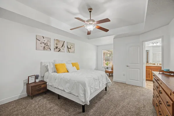 a bedroom with a bed and a chandelier