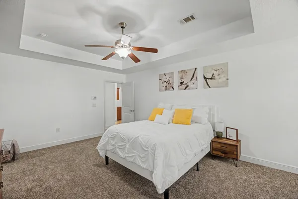 a bedroom with a bed and a chandelier