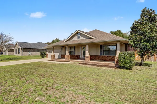 a front view of a house with garden