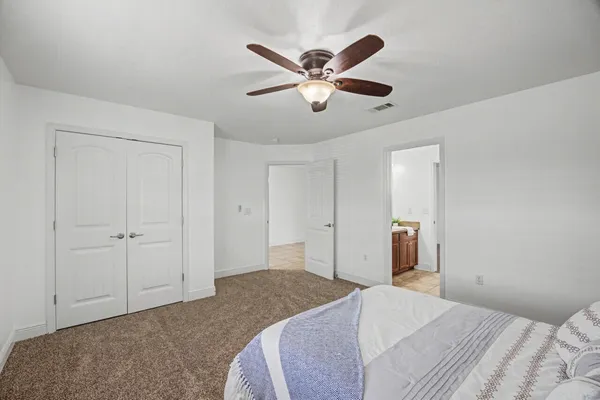 a view of room with a ceiling fan and a window