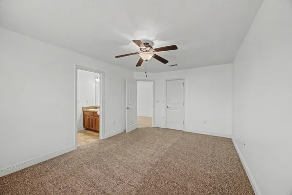 a bathroom with a toilet and shower curtain