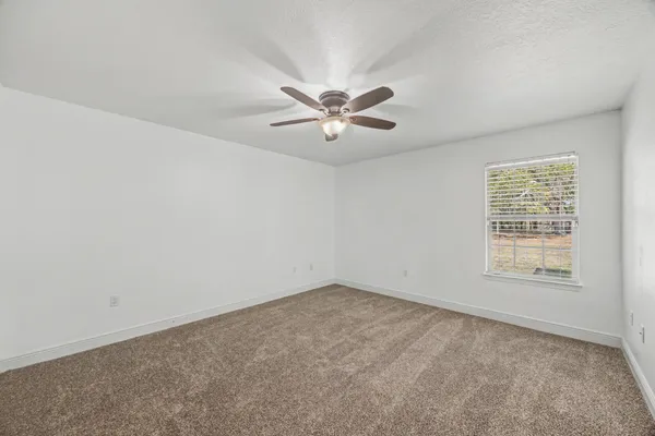 a bathroom with a granite countertop sink toilet a mirror a vanity and shower