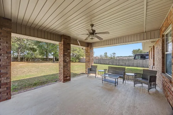 a view of house with backyard and trees