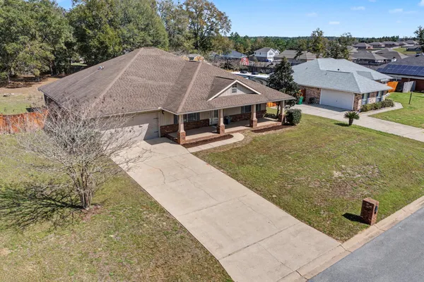 an aerial view of residential houses with outdoor space