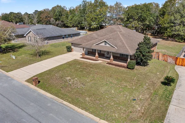 an aerial view of a house with a yard swimming pool and outdoor seating