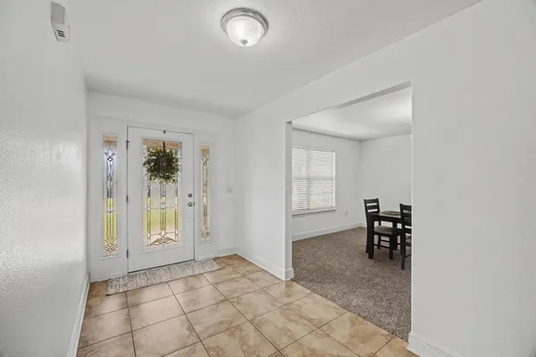 an empty room with windows and furniture