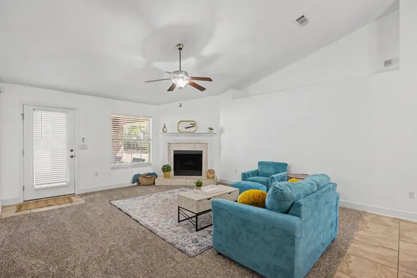 a living room with furniture and a fireplace